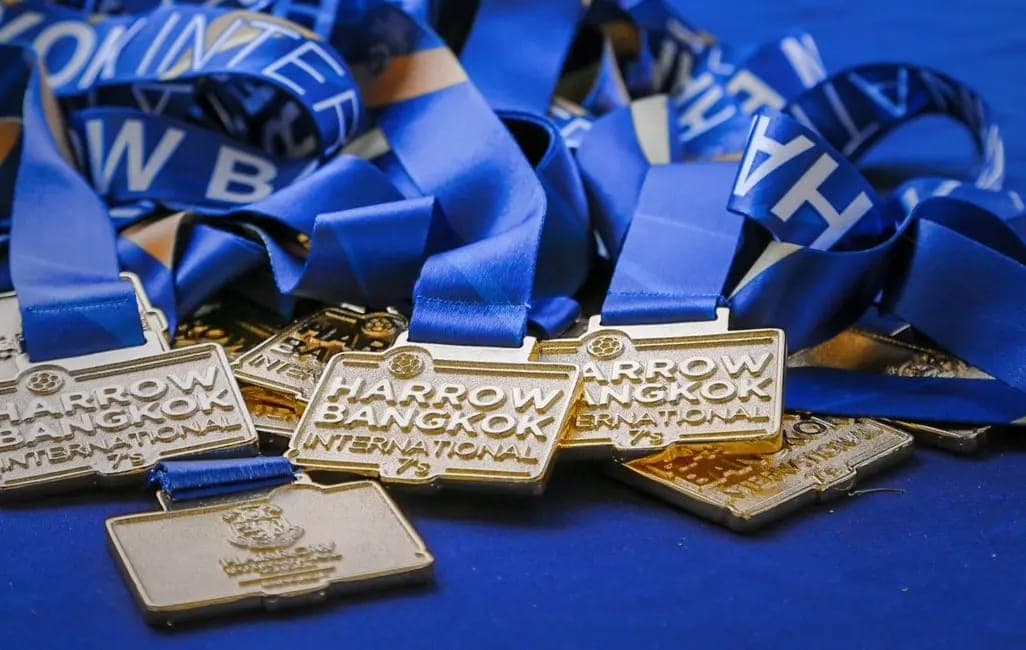 The medals from the Harrow Bangkok International tournament laid out together
