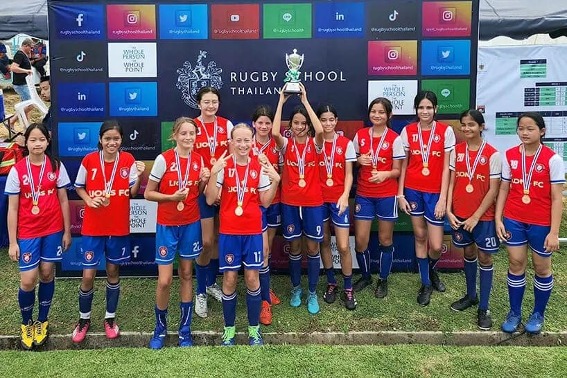 The squad with their bronze medals and trophy at the Rugby School tournament in Pattaya