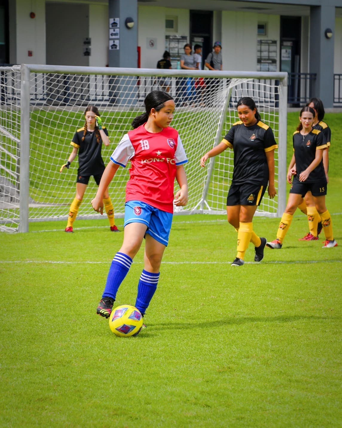A player on the ball, looking up for a pass during a match