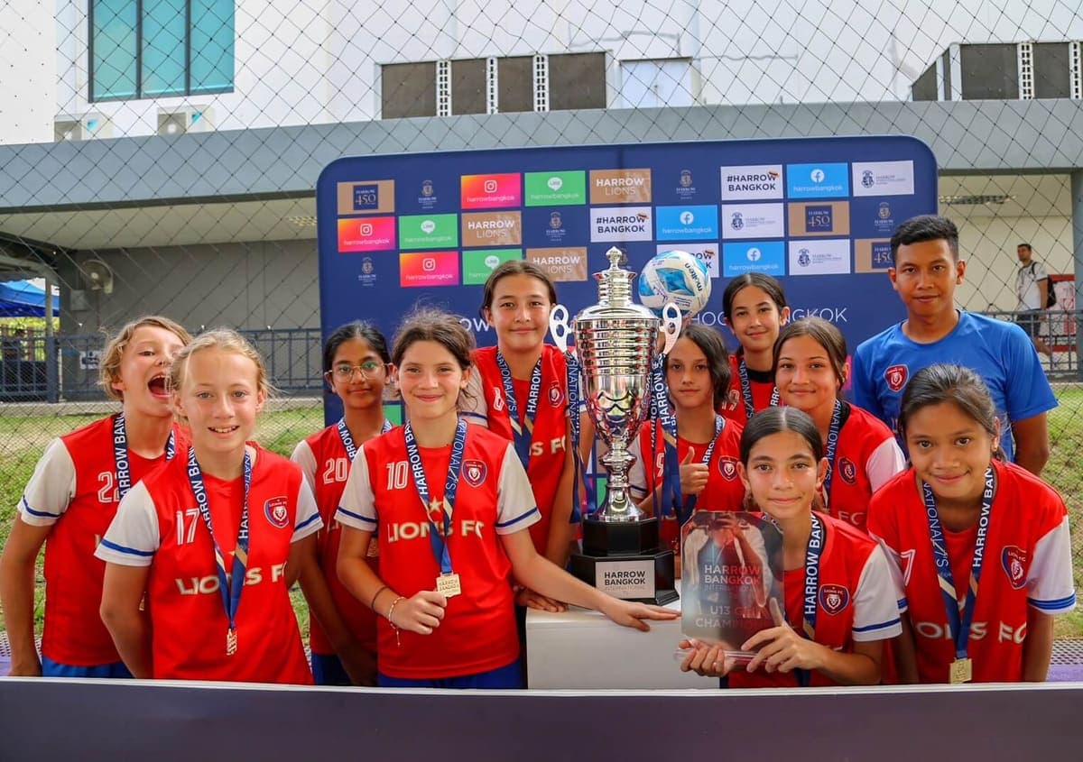 The squad behind the cup they had just won, at the tournament backdrop