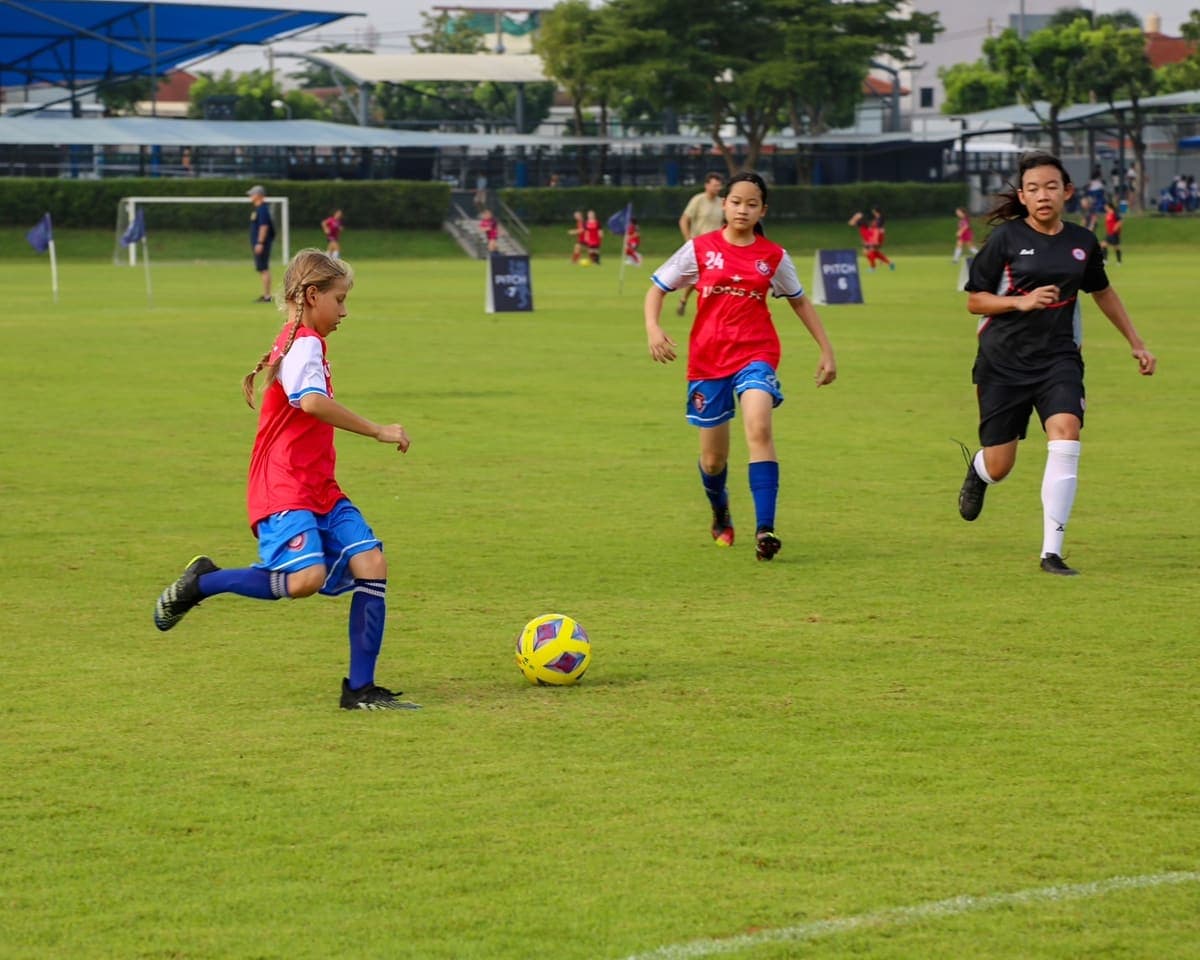 A player striking a long ball upfield during a match