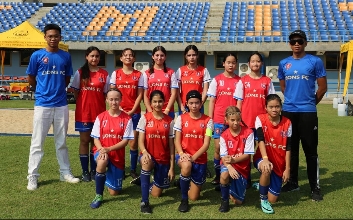 The squad lined up with two coaches in front of the stand at a tournament