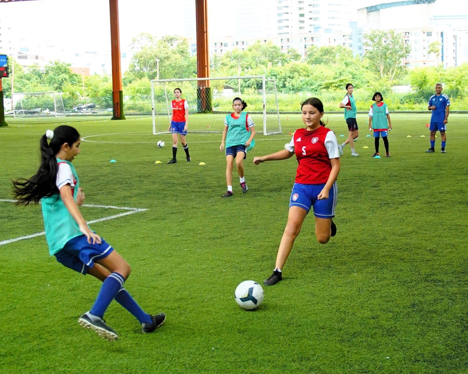 Players shooting during a training session on the outdoor pitch