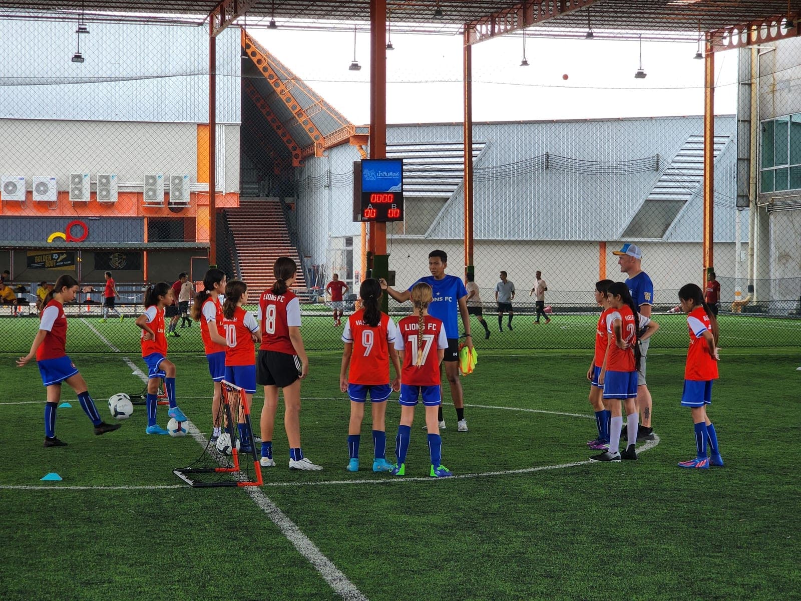 The squad gathered in a circle on the covered pitch at the start of a session