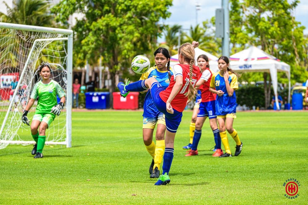 A crowded goalmouth, with the goalkeeper coming out to claim the ball