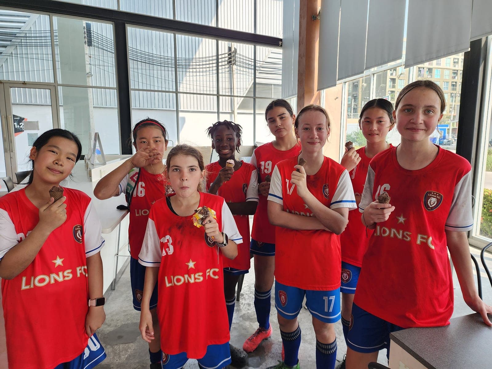 Players together off the pitch after a session, still in club kit