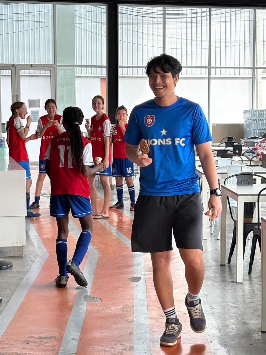 A coach walking with players off the pitch